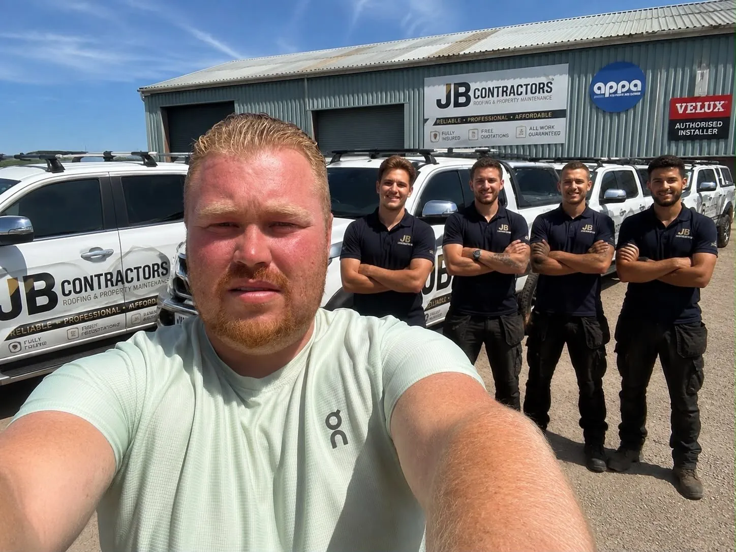 The Totnes Roofing team with their vans outside the yard